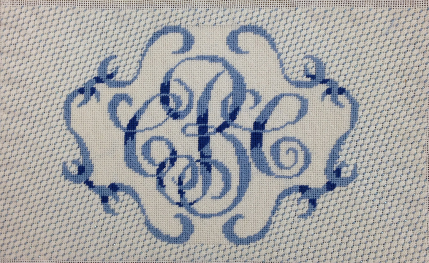 Monogram with scroll border and stitch guide